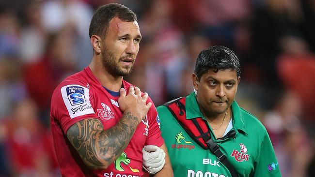 BRISBANE, AUSTRALIA - MAY 17: Quade Cooper of the Reds leaves the field injured during the round 14 Super Rugby match between the Reds and the Rebels at Suncorp Stadium on May 17, 2014 in Brisbane, Australia. (Photo by Chris Hyde/Getty Images)