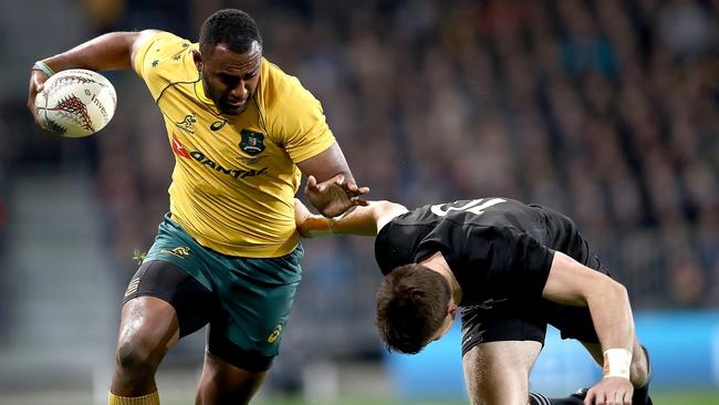 Tevita Kuridrani of the Wallabies is tackled by Beauden Barrett of the All Blacks.