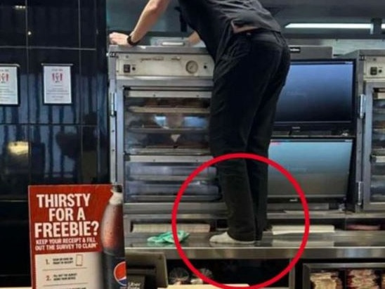 A KFC employee has been spotted standing on the counter without shoes. Picture: 7News