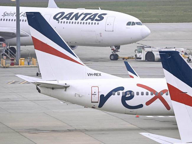 Rex Airlines Boeing 737 planes lay idle on the tarmac at Melbourne's Tullamarine Airport on July 31, 2024. The Australian regional airline Rex cancelled flights as it entered voluntary administration on July 31, leaving the fate of the country's third-largest carrier in serious doubt. (Photo by William WEST / AFP)