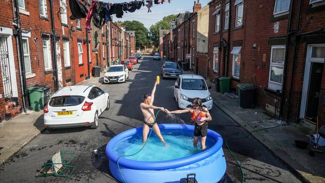 Residents take a dip in a paddle pool outside their home in Leeds during the United Kingdom’s record-breaking heatwave. Picture: Getty Images