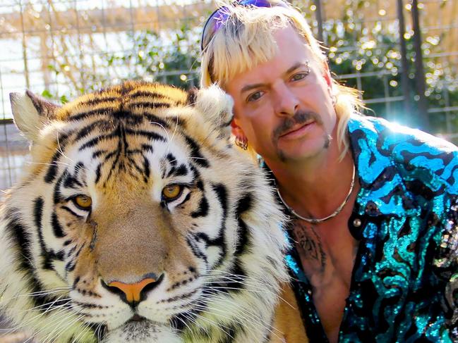 (FILES) In this file undated photo courtesy of Netflix shows Joseph "Joe Exotic" Maldonado-Passage with one of his tigers obtained on january 20, 2020. - A new episode of Netflix's wildly popular "Tiger King" will air this weekend, the company said on April 9, 2020, bringing fans up-to-date with the lives of the smash hit zookeeper documentary's surreal subjects. The series about a gay, mullet-wearing private zoo owner who calls himself "Joe Exotic" -- now in prison for murder-for-hire -- has become a US cultural phenomenon, providing welcome relief to a nation under coronavirus lockdown. (Photo by - / Netflix US / AFP) / RESTRICTED TO EDITORIAL USE - MANDATORY CREDIT "AFP PHOTO / NETFLIX" - NO MARKETING - NO ADVERTISING CAMPAIGNS - DISTRIBUTED AS A SERVICE TO CLIENTS