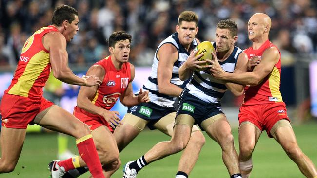 Suns champion Gary Ablett tackling former Geelong teammate Joel Selwood. Picture: AAP