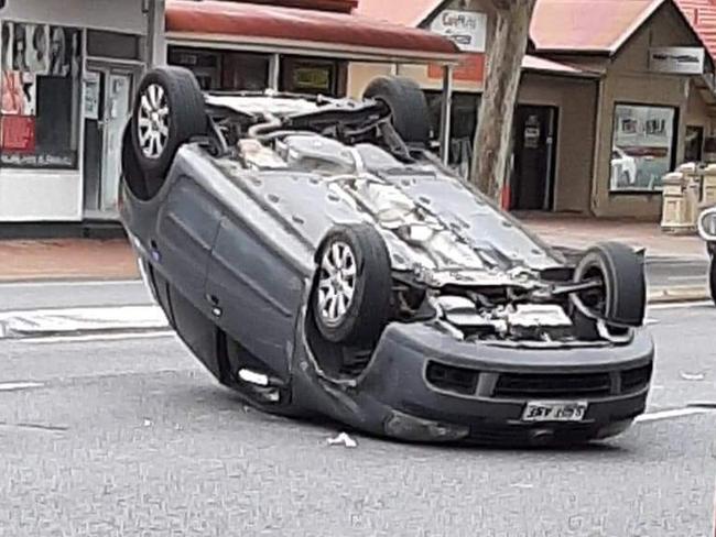 At around 10am a Volkswagen Golf turning onto Henley Beach road collided with an oncoming bus, causing the hatchback to become airborne. picture Riley Walter