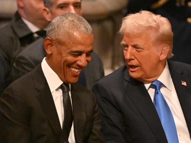 Former US President Barack Obama speaks with President-elect Donald Trump before the State Funeral Service for former US President Jimmy Carter.