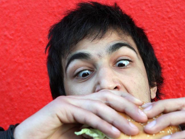 Ahmed Jammoul, 19 of Murray Bridge, eats a Hungry Jack's Ultimate Double Whopper hamburger that has 80g of fat and more than 1200 calories.