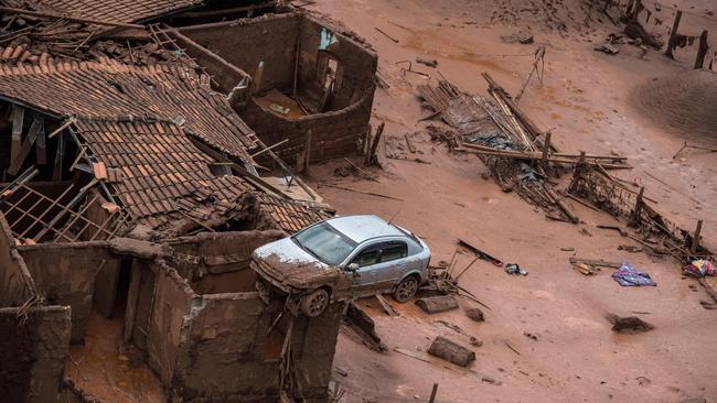 Aerial view taken on November 6, 2015, shows the village of Bento Rodrigues following the bursting of a dam, at a mining waste site, of the company Samarco, jointly owned by Vale of Brazil and BHP, unleashing a deluge of thick, red toxic mud.