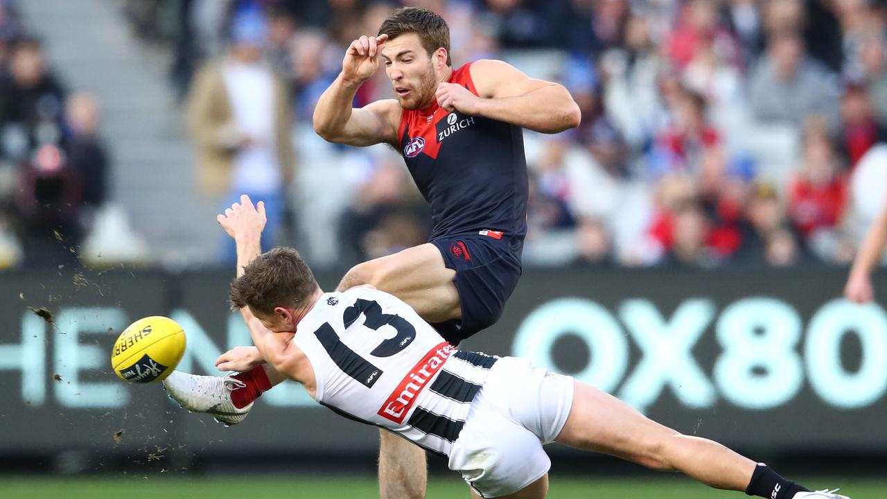 Taylor Adams smothers Jack Viney at the MCG on Monday.