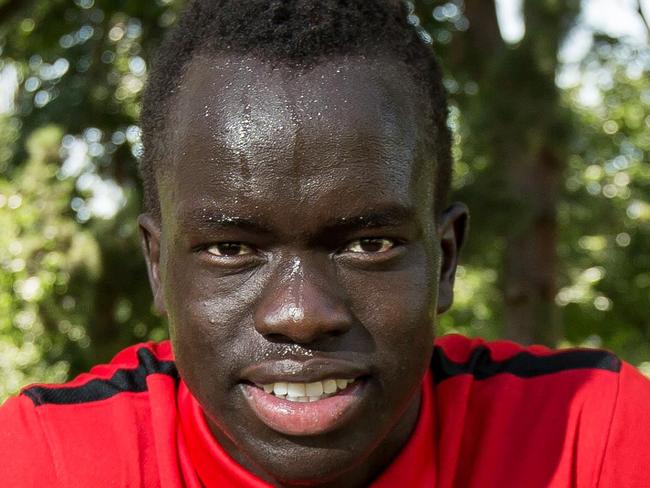 18/12/2015: Adelaide United star Awer Mabil poses with a soccer ball in a park in Adelaide. Mabil was born at the Kakuma refugee camp in northwest Kenya before migrating to Australia. He is the face of Barefoot to Boots, launched by Foreign Minister Julie Bishop earlier this year. The charity is looking to expand to Syrian refugees in Turkey. James Elsby/The Australian