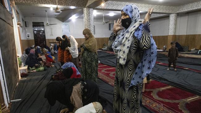 Displaced Afghan women and children from Kunduz pray at a mosque that is sheltering them in Kabul, Afghanistan. Picture: Getty