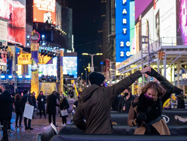 NEW YORK, NY – DECEMBER 31: Revellers celebrate New Years Eve in socially distanced pods at Times Squar. Picture: David Dee Delgado/Getty Images/AFP