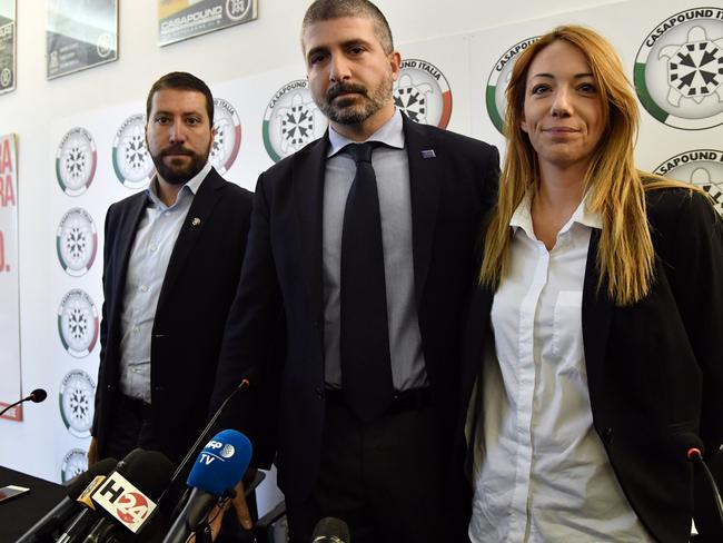Members of Italy's far-right CasaPound movement, Luca Marsella (L), CasaPound Vice-President Simone Di Stefano (C) and Carlotta Chiaraluce prepare to speak during a press conference at CasaPound's headquarters in Rome on November 9, 2017.  Italy reeled on November 9 from images of an attack on a journalist by a mobster in a Rome suburb, as local prosecutors opened an investigation. Daniele Piervincenzi, who works for the Rai national television broadcaster, was asking the brother of a famous mafia boss about his ties to the far-right CasaPound movement when he was set upon on camera in Ostia.  / AFP PHOTO / TIZIANA FABI