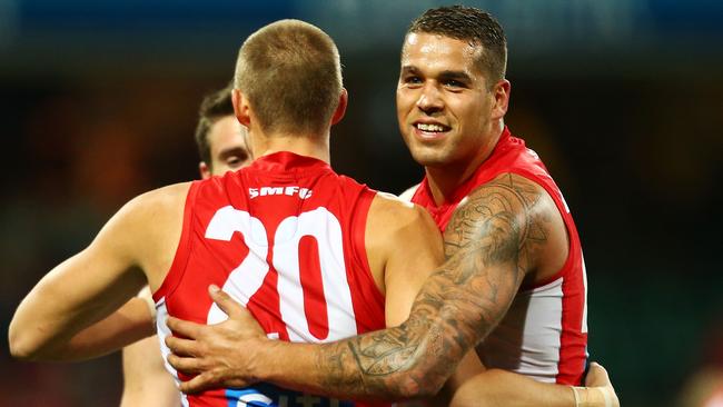 Lance Franklin celebrates a goal with his teammates.