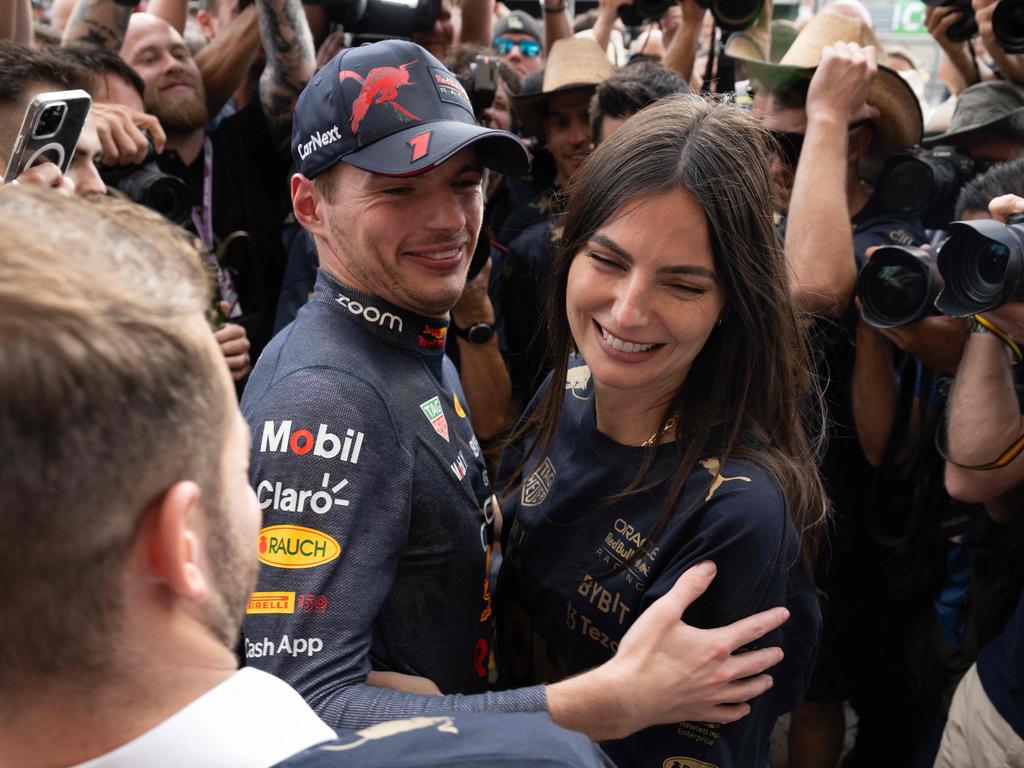 Red Bull Racing's Dutch driver Max Verstappen (C) hugs his girlfriend Kelly Piquet as the Red Bull Racing team celebrates winning the Constructors title.