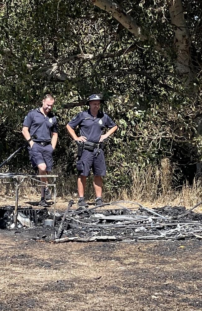 Police investigate the tent and grassfire at a campsite used by homeless people in Bundaberg.