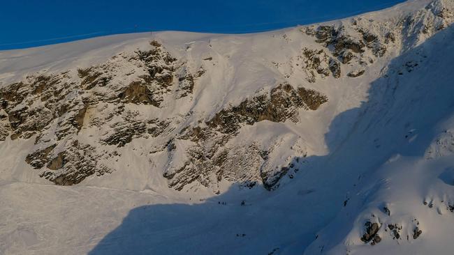 Rescuers search for two people believed missing after an avalanche struck skiers. Picture: AFP