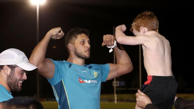 Adam Coleman and a young Wallabies supporter flex at each other at Cessnock Sportsground.