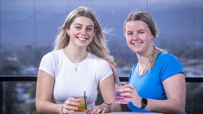 ADELAIDE, AUSTRALIA – Advertiser Photos JUNE 25, 2022: Yasmin Milne and Hailey Wright from Melbourne enjoy the views over Adelaide at the bar and pool deck at Crowne Plaza Hotel on Frome St. Picture: Emma Brasier