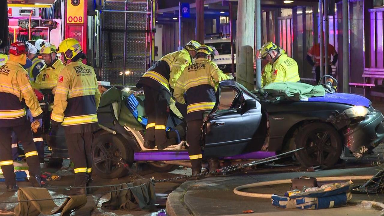 Pictured are emergency services attending a car crash after a Police pursuit on Railway Parade, Canley Vale when the vehicle being pursued lost control and hit a telegraph pole trapping two people. Picture: TNV