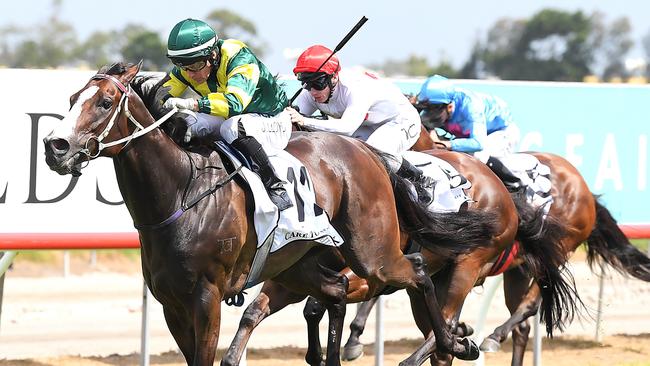 Jockey Jeff Lloyd rides Care To Think to win the Magic Millions Cup. Picture: Albert Perez, AAP Image.