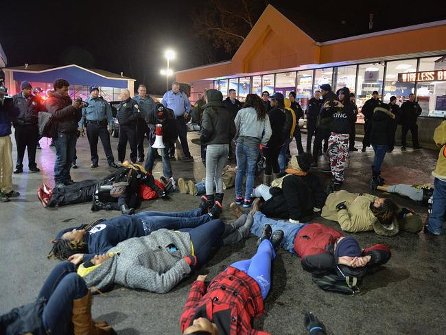 Do or die ... Demonstrators participate in a die-in protest outside the Mobil On-The-Run gas and convenience store in Berkeley. Source: AFP