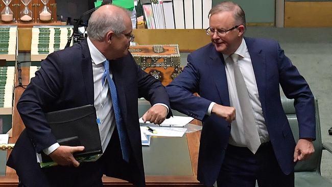 Scott Morrison and Anthony Albanese bump elbows at the conclusion of Question Time in the House of Representatives at Parliament House in Canberra on Thursday. Picture: Getty Images