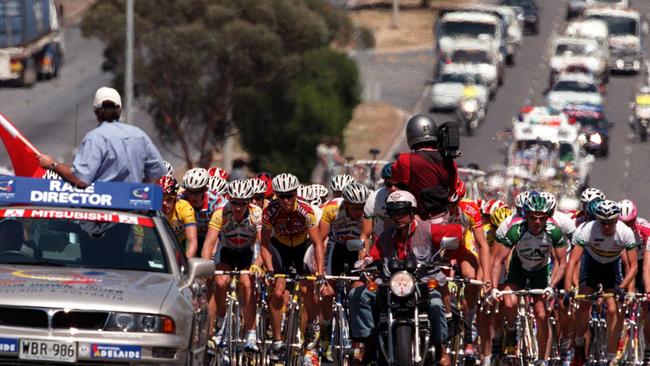 Official Mike Turtur and cyclists on Grand Junction Road during fourth stage of Tour Down Under in 1999.