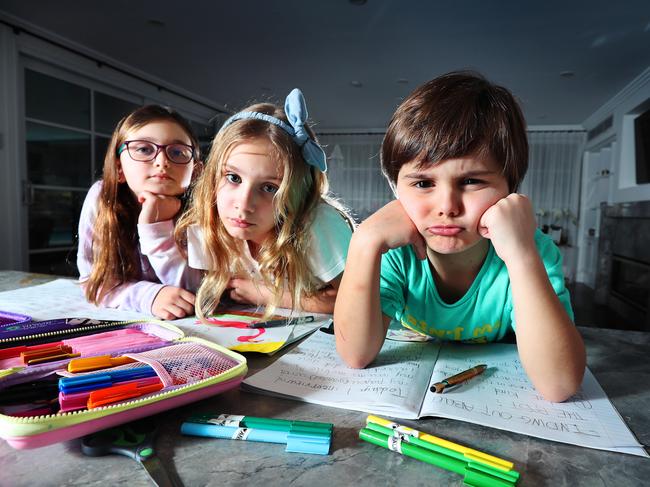 Olivia, 7, Annalise, 9, and George, 5, learn from home. Picture: Rebecca Michael