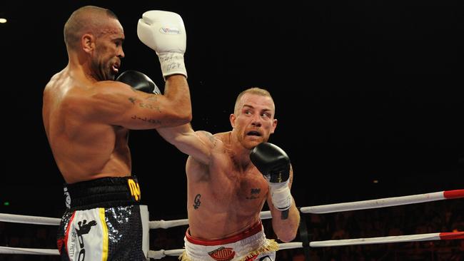 Australian boxers Anthony Mundine (left) and Garth Wood fight during are-match in Brisbane in 2011. Picture: Dave Hunt