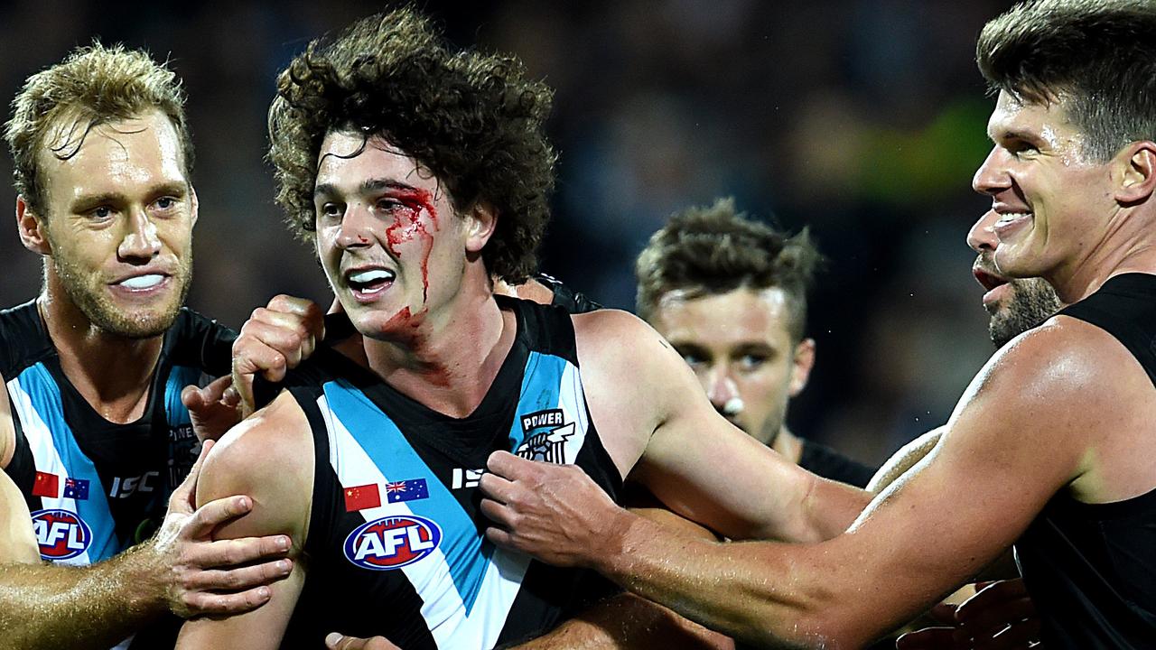 Teammates get to Byrne-Jones after his goal on debut in 2016. Picture: Sam Wundke.