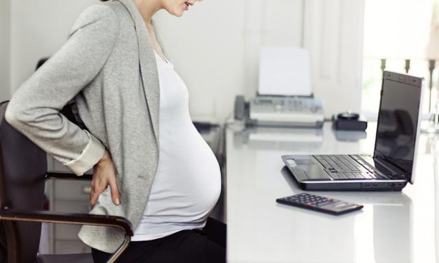 Pregnant woman feeling sick at work
