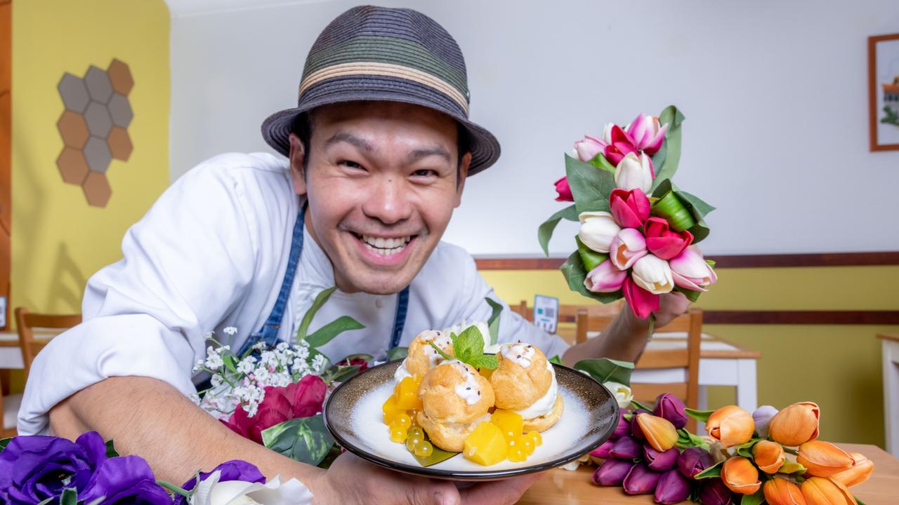 Yodthai's Nick Ngowsakul with his homemade coconut ice cream with sticky rice, covered with puff pastry and served with mango, pineapple and bubble pearls and edible flowers. Picture: Luke Marsden.