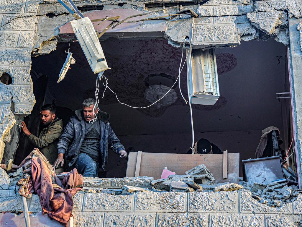 People inspect debris and rubble in a building heavily damaged by Israeli bombardment in Rafah. Picture: AFP