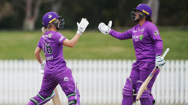 Nicola Carey, left, celebrates her half century with Chloe Tryon during Sunday’s game. Picture: AAP