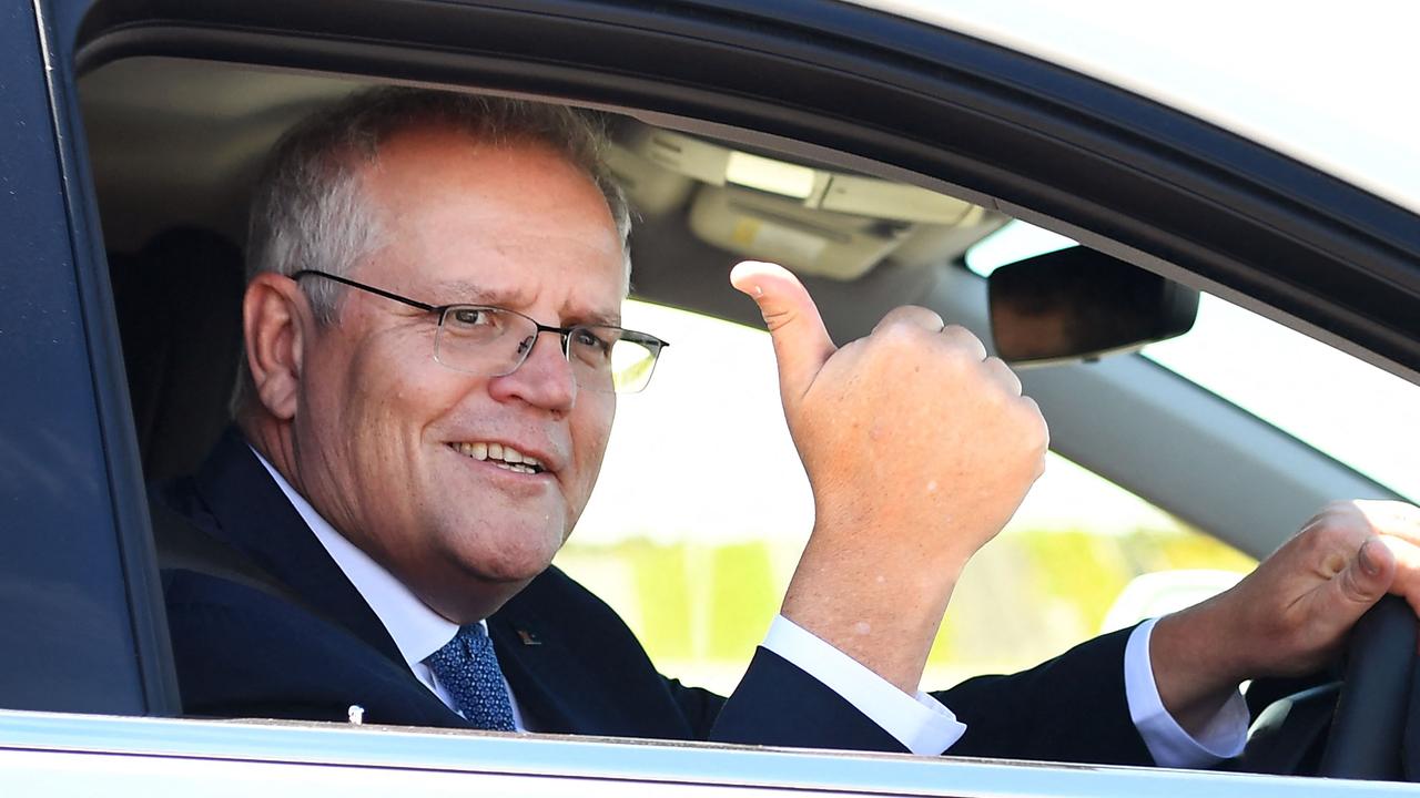 Prime Minister Scott Morrison gives the thumbs up from a hydrogen-powered car. Picture: William West/AFP