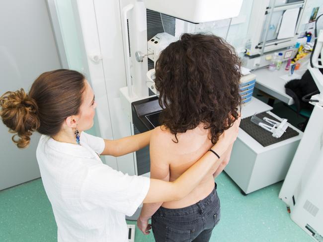 Nurse with young women having a mammography