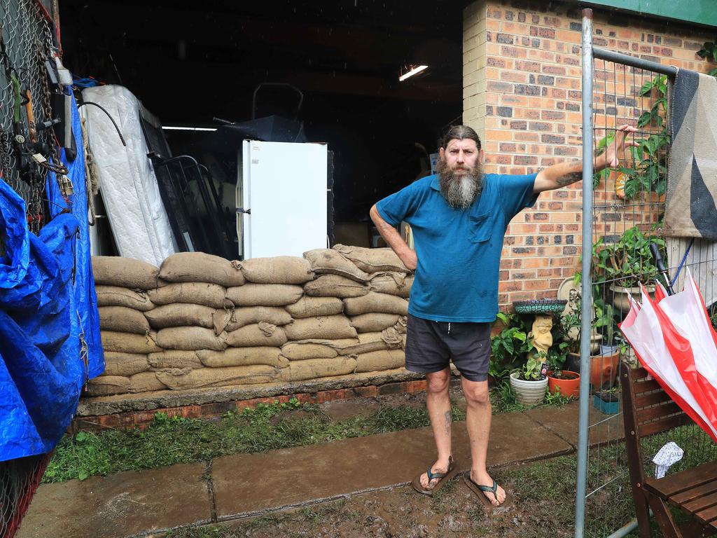 Jason Adams sandbags his Church Street, Windsor home, which is under threat from floodwaters. Picture: John Feder