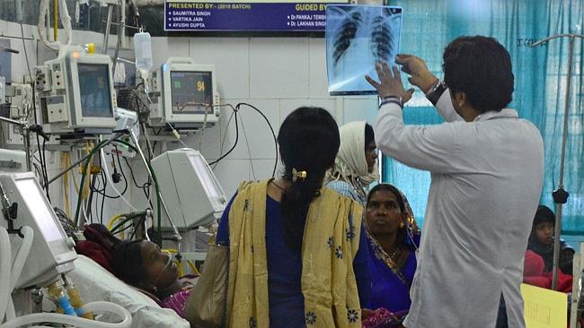 A doctor talks with a patient in the intensive care ward at the Chhattisgarh Institute of Medical Science hospital in Bilaspur who suffered from complications after undergoing mass sterilisation in a government-run program.