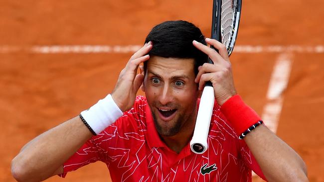 Serbia's Novak Djokovic reacts as he takes part in tennis match during a charity exhibition hosted by him, in Belgrade on June 12, 2020. - Novak Djokovic has also tested positive for coronavirus on June 23, 2020 along with Grigor Dimitrov, Borna Coric and Viktor Troicki, after taking part in an exhibition tennis tournament in the Balkans featuring world number one Novak Djokovic, raising questions over the sport's planned return in August. (Photo by Andrej ISAKOVIC / AFP)