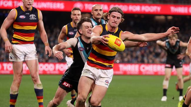 ADELAIDE, AUSTRALIA - AUGUST 20: Sam Berry of the Crows is tackled by Zak Butters of the Power during the 2022 AFL Round 23 match between the Port Adelaide Power and the Adelaide Crows at Adelaide Oval on August 20, 2022 in Adelaide, Australia. (Photo by Sarah Reed/AFL Photos via Getty Images)