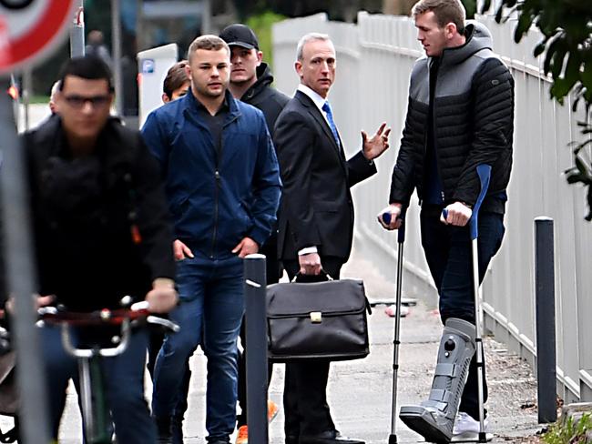 Grenoble's French hooker Loick Jammes (2ndL) and Grenoble's Irish centre Chris Farrell (R) arrive at the police station in Grenoble, French Alps. Picture:  AFP