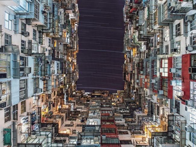 City Lights ... Star trails depicting the movement of the Earth, gently arc over the towering buildings peppered with neon signs and light pipes in the bustling Quarry Bay of Hong Kong. The light pollution in Hong Kong means that only a few stars are generally visible in the night sky, but this photograph shows that despite this you can still engage in some stargazing wherever you are in the world. Picture: Wing Ka Ho, Insight Astronomy Photographer of the Year 2016 People and Space Winner