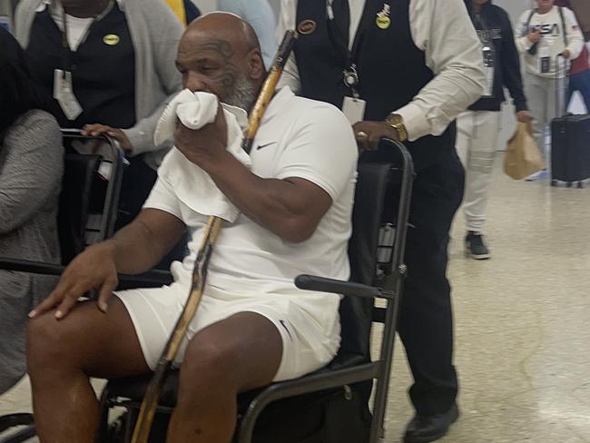 ONE TIME WEB USE FOR NEWS.COM.AU STORY ONLY - FEES APPLY - CONTACT AGENCY FOR ANY OTHER USE -  08/16/2022 EXCLUSIVE: Mike Tyson is pictured in a wheelchair at Miami International Airport. The 56 year old former professional boxer was pictured after slamming an upcoming Hulu limited series for 'stealing' his life story. sales@theimagedirect.com Please byline:TheImageDirect.com*EXCLUSIVE PLEASE EMAIL sales@theimagedirect.com FOR FEES BEFORE USE  Picture: TheImageDirect.com