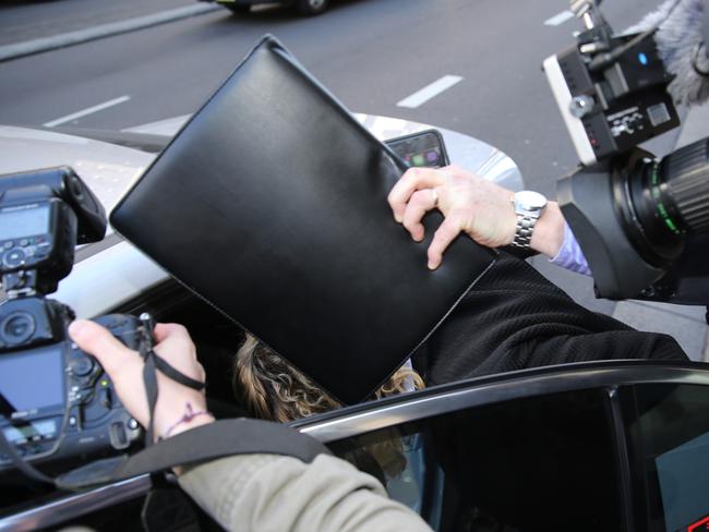 Kate DeAraugo slips into a taxi after appearing in court in 2015. Picture: John Grainger