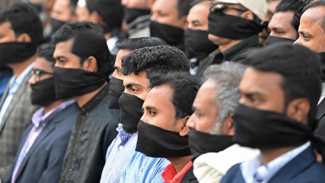 Members of the Bangladesh Gono Odhikar Parishad party wearing black face bands take part in a protest to condemn the general election, in Dhaka on Sunday. Picture: AFP