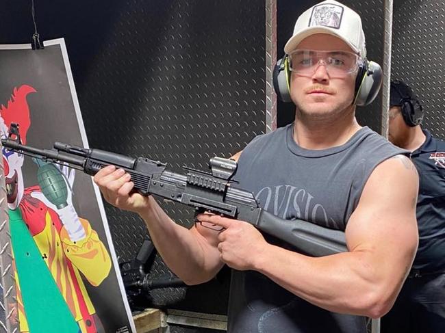 NRL players in summer: Canberra Raiders forward Hudson Young poses with an AK-47 at a gun shop in Las Vegas. Picture: Instagram