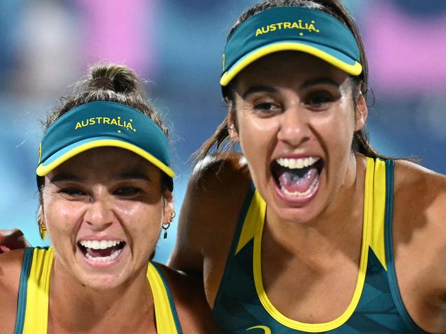 Australia's #01 Mariafe Artacho Del Solar and Australia's #02 Taliqua Clancy celebrate their victory in the women's quaterfinal beach volleyball match between Australia and Switzerland during the Paris 2024 Olympic Games at the Eiffel Tower Stadium in Paris on August 6, 2024. (Photo by CARL DE SOUZA / AFP)