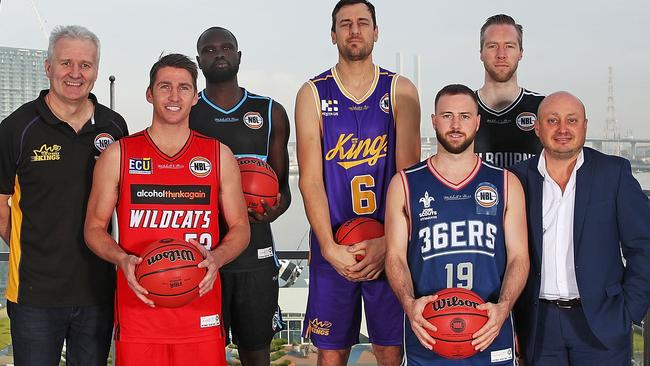 (L-R) Andrew Gaze, coach of the Sydney Kings; Damian Martin of the Perth Wildcats; Majok Majok of the New Zealand Breakers; Andrew Bogut of the Sydney Kings; Adam Doyle of the Adelaide 36ers; David Barlow of Melbourne United and NBL Chief Executive Officer, Larry Kestelman pose during pose at the announcement of the plan for five NBL teams will travel to the U.S. to participate in the NBA preseason. Picture: Getty Images