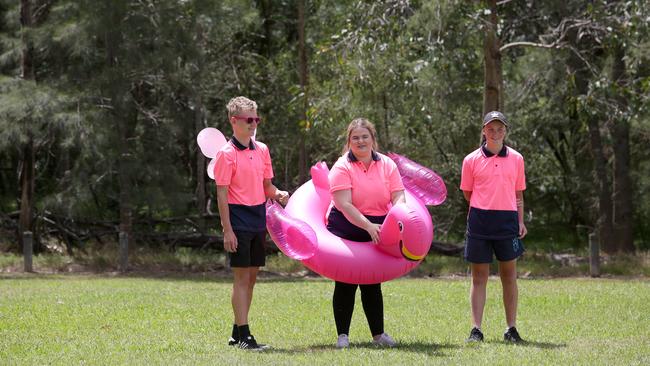 Participants have fun at the friendly game of cricket.