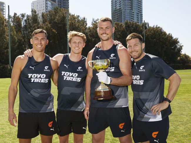 GWS Giants players Isaac Cumming, Lachie Whitfield, Kieren Briggs and Toby Greene with the Lexus Melbourne Cup trophy as part of its visit to Sydney. Picture: Jay Patel